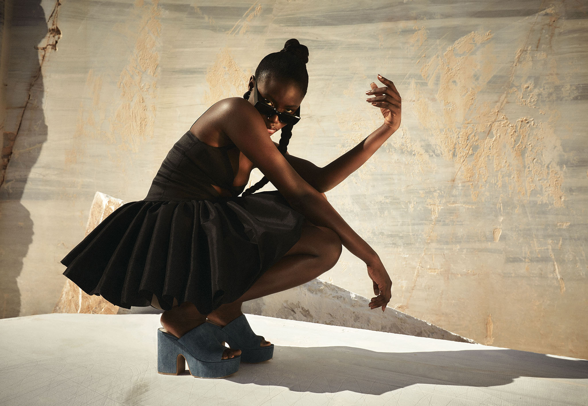 Photo of a Nine West Model in a stylish black dress wearing Signal Brands designed leather shoes.